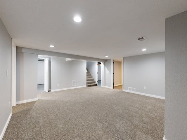 Newly finished legal basement apartment with staircase and neutral walls